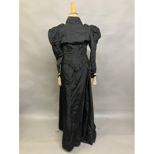 325 - A c 1890’s/900 black silk two-piece ensemble, the tailored bodice with gathers to the shoulder and s... 