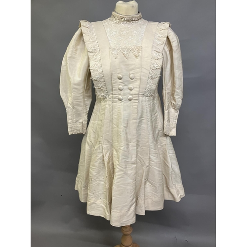 328 - An early 20th century dress for a young girl, cream glazed cotton (?) with chemical lace trimming, h... 