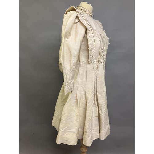 328 - An early 20th century dress for a young girl, cream glazed cotton (?) with chemical lace trimming, h... 