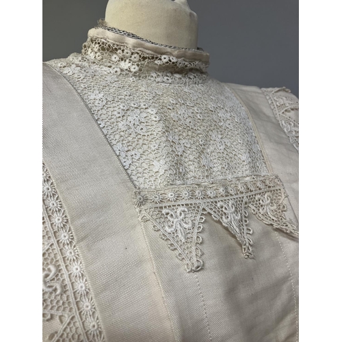 328 - An early 20th century dress for a young girl, cream glazed cotton (?) with chemical lace trimming, h... 