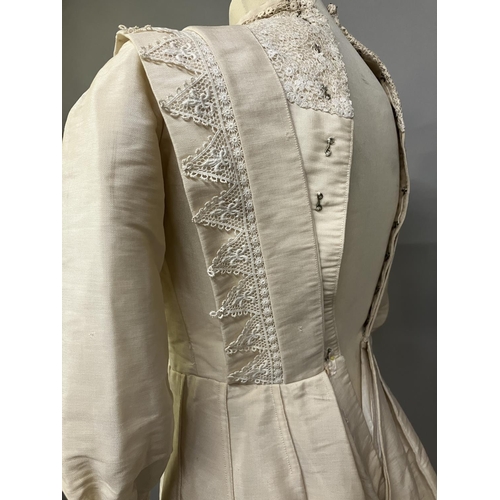 328 - An early 20th century dress for a young girl, cream glazed cotton (?) with chemical lace trimming, h... 