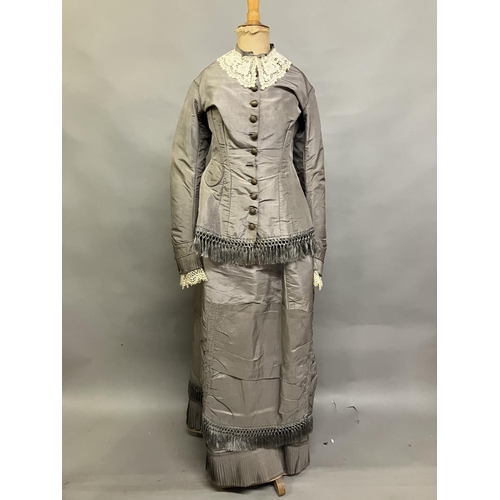 331 - A c 1880’s two piece light grey silk ensemble, the long-line bodice tailored and shaped at the back ... 