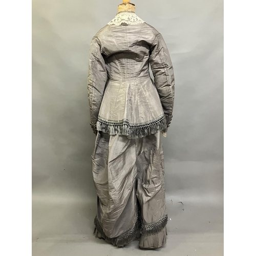 331 - A c 1880’s two piece light grey silk ensemble, the long-line bodice tailored and shaped at the back ... 