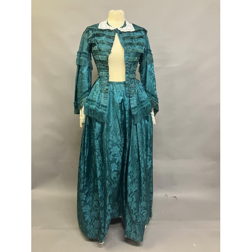 333 - An 1870’s watered silk two piece costume, a vibrant green with floral design, the skirt with machine... 