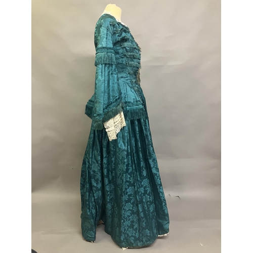 333 - An 1870’s watered silk two piece costume, a vibrant green with floral design, the skirt with machine... 