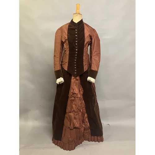 335 - A c 1880’s century two piece costume, mid-brown silk and darker velvet, the bodice with straight sle... 