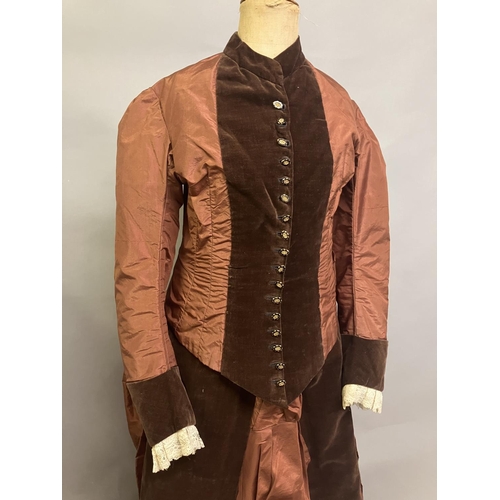 335 - A c 1880’s century two piece costume, mid-brown silk and darker velvet, the bodice with straight sle... 