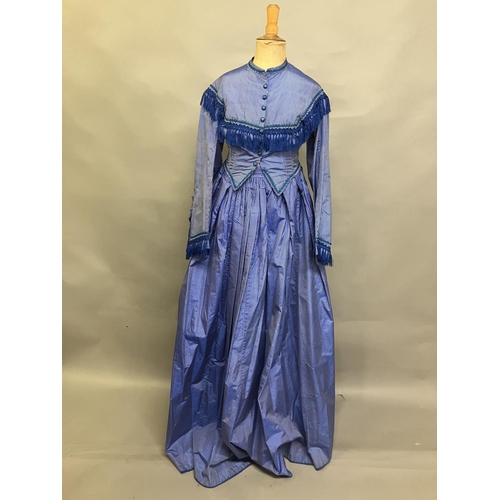 337 - C 1865, a striped blue silk two-piece ensemble, short bodice with rear detail, trimmed with fringing... 