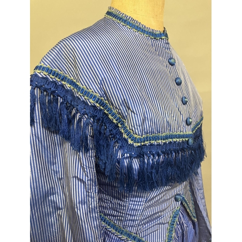 337 - C 1865, a striped blue silk two-piece ensemble, short bodice with rear detail, trimmed with fringing... 