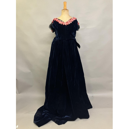 339 - A mid-19th century two-piece velvet evening ensemble, very dark navy, full, trained skirt, the bodic... 