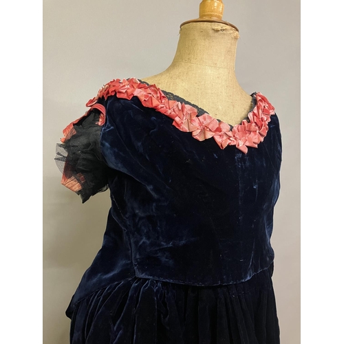 339 - A mid-19th century two-piece velvet evening ensemble, very dark navy, full, trained skirt, the bodic... 