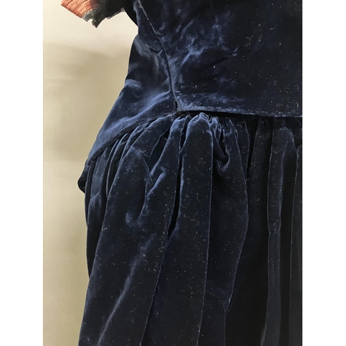 339 - A mid-19th century two-piece velvet evening ensemble, very dark navy, full, trained skirt, the bodic... 