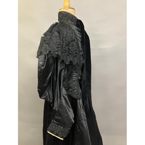 340 - C 1895/1900, a two piece black silk satin skirt and boned bodice bearing the attribution, in gold on... 