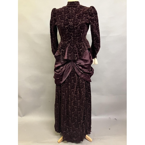 344 - An 1880’s cut velvet two piece in ruby, the tailored jacket boned and lined in patterned cotton, the... 