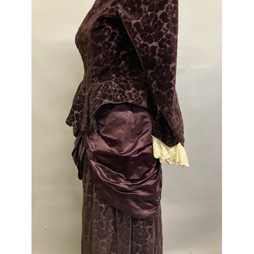 344 - An 1880’s cut velvet two piece in ruby, the tailored jacket boned and lined in patterned cotton, the... 