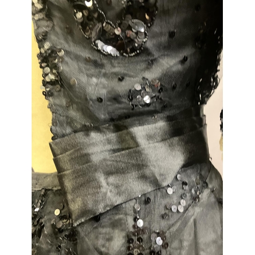 345 - An extravagant sequined and beaded evening ensemble of skirt and bodice, black, the bodice of net wi... 