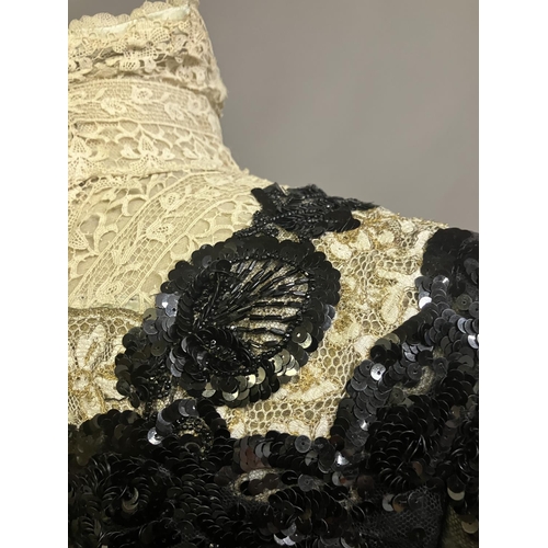 345 - An extravagant sequined and beaded evening ensemble of skirt and bodice, black, the bodice of net wi... 