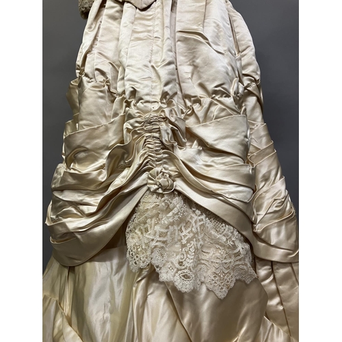 355 - An elaborate 1880’s wedding or evening gown, skirt with integral boned bodice, a heavy honey silk, r... 