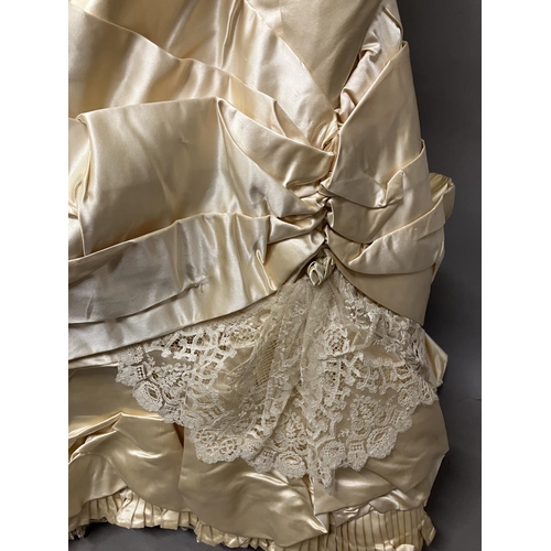 355 - An elaborate 1880’s wedding or evening gown, skirt with integral boned bodice, a heavy honey silk, r... 