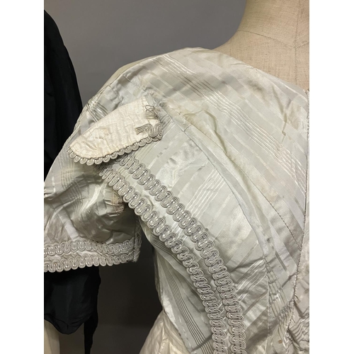 357 - Miscellaneous costume: a mid-19th century boned bodice in eau de nil striped silk, trimmed with brai... 