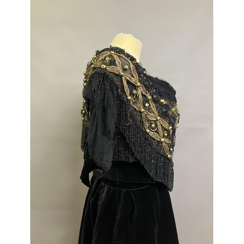 358 - A mid-19th century black velvet evening two piece, the full skirt plain, the bodice rear-lacing, wit... 