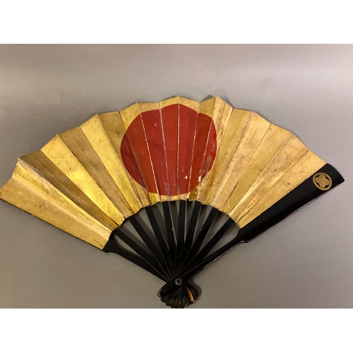 123 - A Japanese war fan, with central feature, the hinomaru, or sun-disk shown in red on a gold-leaf grou... 