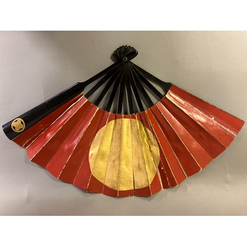 123 - A Japanese war fan, with central feature, the hinomaru, or sun-disk shown in red on a gold-leaf grou... 