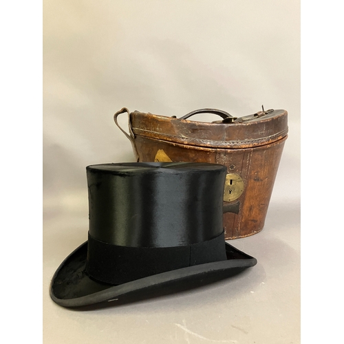 299B - A leather top hat case lined in purple velvet, and silk top hat by Lock and Co. (hat + case) (Shippi... 