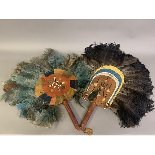 120 - A North American Indian feather fixed fan, 19th century, applied with a small bird, the shaped handl... 