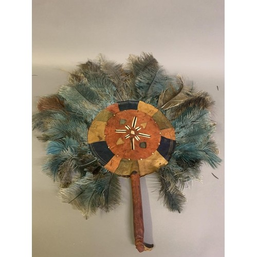 120 - A North American Indian feather fixed fan, 19th century, applied with a small bird, the shaped handl... 