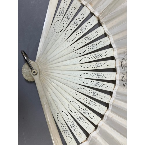 10 - C 1890’s, an unusual incised bone fan mounted with a leaf of cream silk, bordered with a floral mach... 