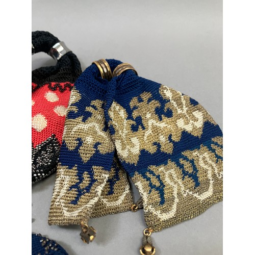 252 - Four large, 19th century miser’s purses, the first crocheted in navy blue with the addition of cream... 