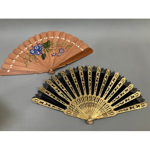 17 - A wood fan, the monture carved and pierced, painted gold, c 1870’s, the black silk satin leaf with b... 