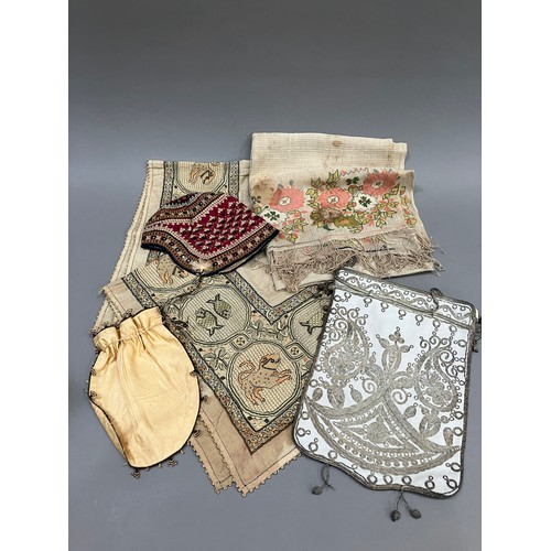 173 - World textiles: an assortment of items comprising a square cloth embroidered in silks with a deep, e... 