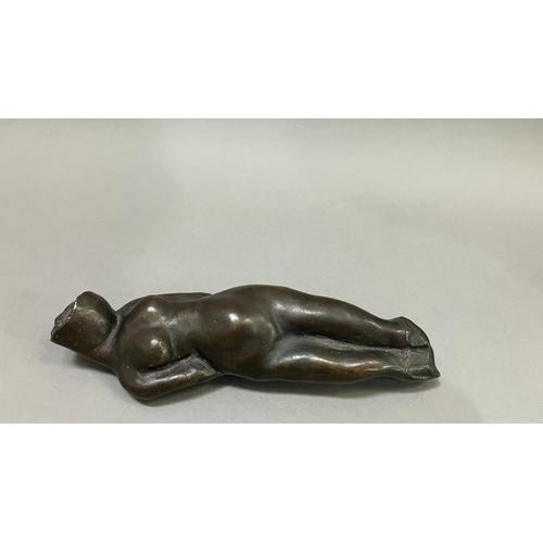 11 - British School mid 20th century, A bronze female nude figure, reclining, 22cm long