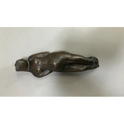 11 - British School mid 20th century, A bronze female nude figure, reclining, 22cm long