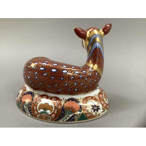 1 - A Royal Crown Derby figure of a deer, recumbent, on an oval base, designed exclusively for the Royal... 