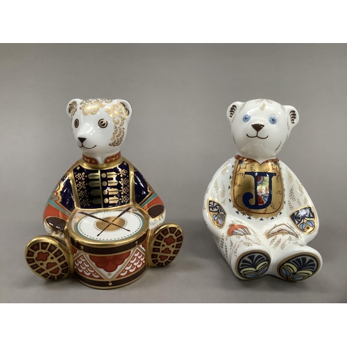 12 - A Royal Crown Derby alphabet bear, gold button, together with drummer bear, 10.5cm and 10cm high