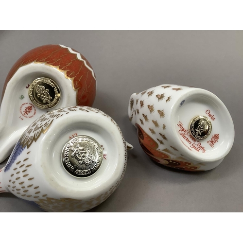 21 - A Royal Crown Derby Collectors Guild owlet paperweight, gilt button, 6cm high together with two bird... 