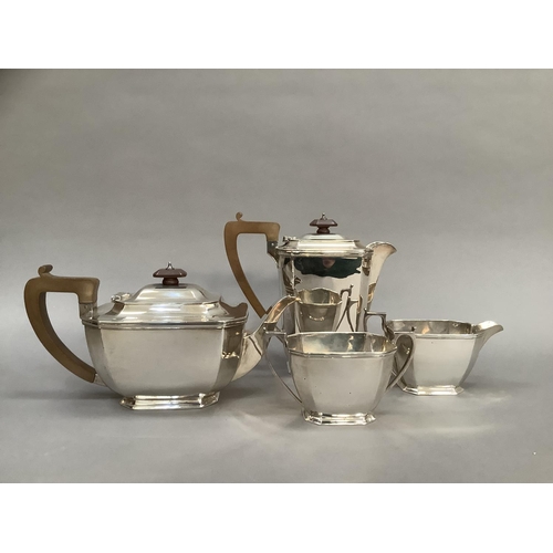 382 - A four piece silver tea service comprising, tea pot and hot water jug with composite handles, two ha... 