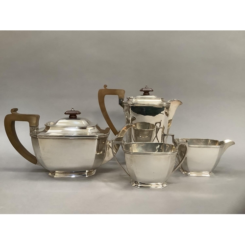 382 - A four piece silver tea service comprising, tea pot and hot water jug with composite handles, two ha... 