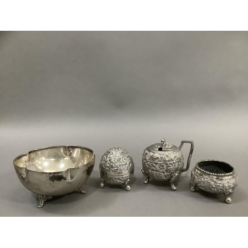 380 - An Indian three piece cruet in white metal (tests as silver) comprising mustard pot, open salt and p... 