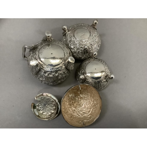 380 - An Indian three piece cruet in white metal (tests as silver) comprising mustard pot, open salt and p... 