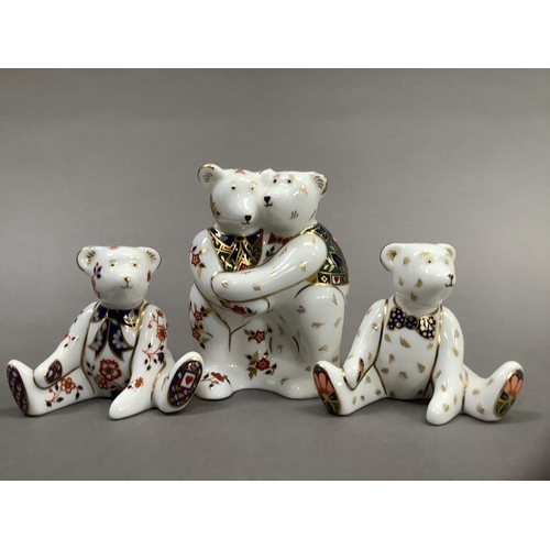 32 - A Royal Crown Derby model of two bears hugging together with two seated bears, 9cm and 6.5cm