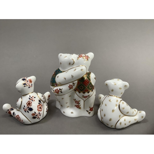 32 - A Royal Crown Derby model of two bears hugging together with two seated bears, 9cm and 6.5cm