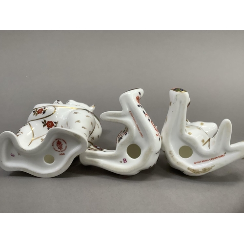 32 - A Royal Crown Derby model of two bears hugging together with two seated bears, 9cm and 6.5cm