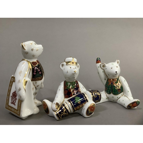 34 - Three Royal Crown Derby teddy bears, Christmas bear with cracker, bear with carrier bag and seated b... 