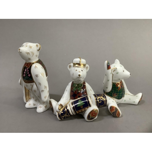 34 - Three Royal Crown Derby teddy bears, Christmas bear with cracker, bear with carrier bag and seated b... 