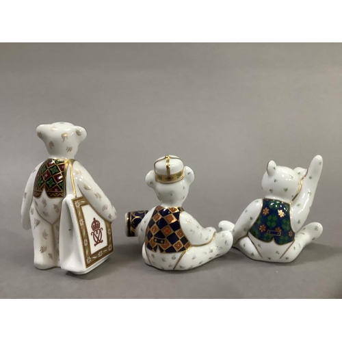 34 - Three Royal Crown Derby teddy bears, Christmas bear with cracker, bear with carrier bag and seated b... 