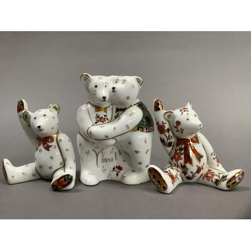 35 - A group of Royal Crown Derby teddy bears including two bears hugging with year 2010 and two seated b... 